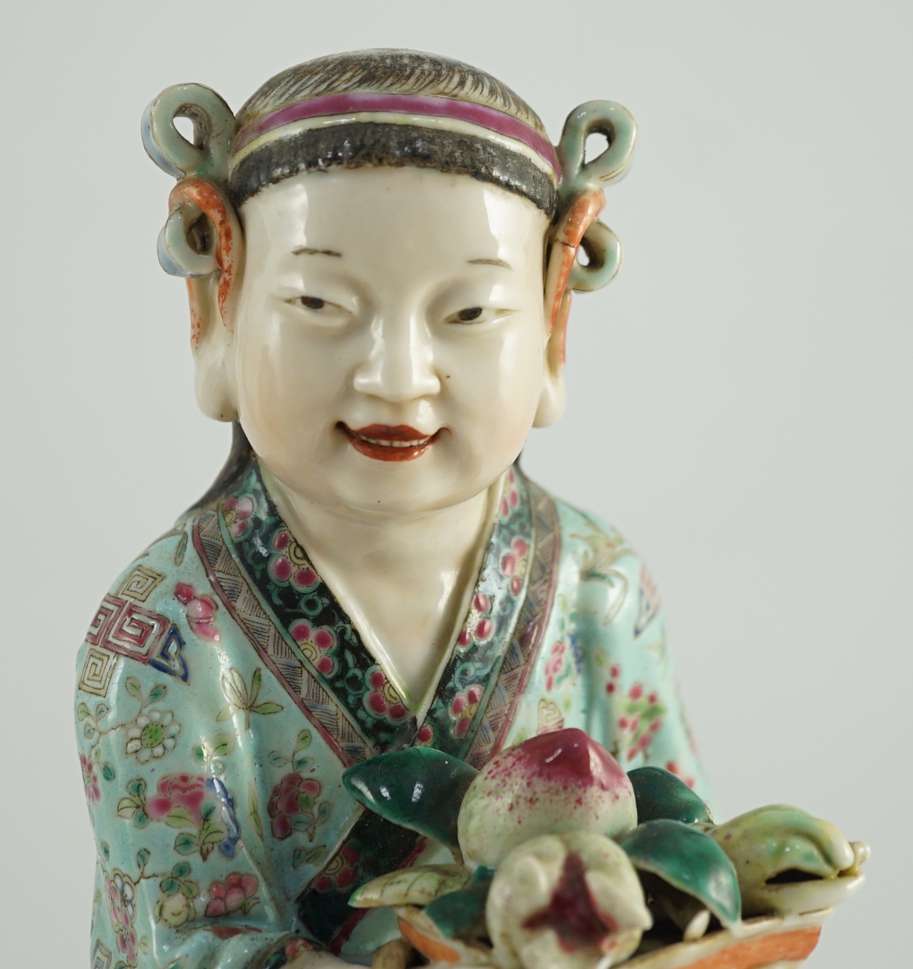 A Chinese enamelled porcelain figure of a boy attendant, early 20th century, 30.5cm high, base broken and re-glued